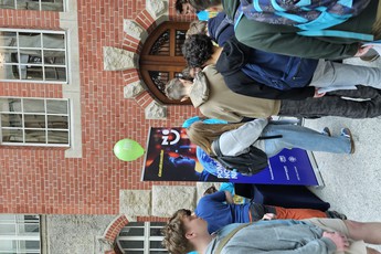 grupa osób na dziedzińcu PG, osoby stoją tyłem lub bokiem